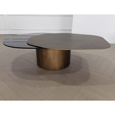 an oval coffee table with two circular tables on the top and bottom, in gold plating