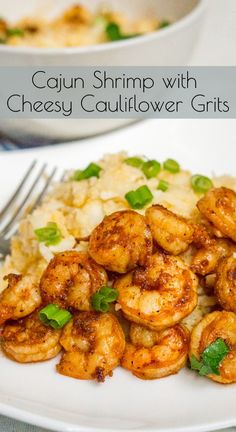 cajun shrimp with cheesy cauliflower grits on a white plate