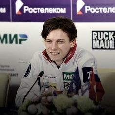 a man sitting in front of a microphone at a press conference