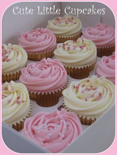 cupcakes with pink frosting and sprinkles in a box