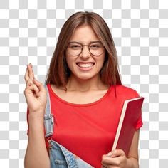 a woman wearing glasses holding a book and pointing to the side with her index finger