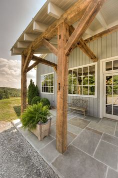 an outdoor covered patio with potted plants