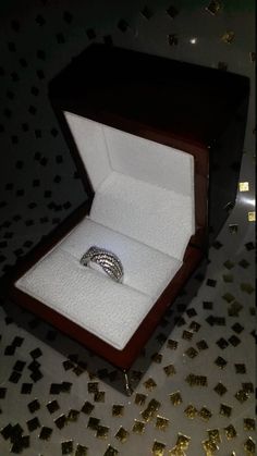 an open box with a ring in it