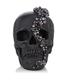 a black skull with pearls on it's head