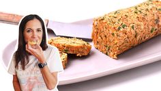 a woman eating something next to a loaf of bread on a plate with a knife