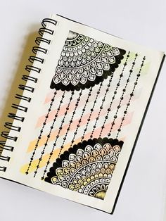 an open notebook with black and white designs on it