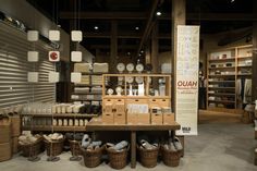 a display in a store filled with lots of different types of items and baskets on the floor