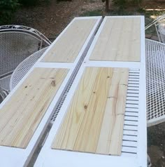 an outdoor table and chairs with wood planks