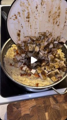 a pan filled with food sitting on top of a stove