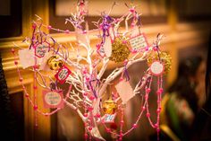 a tree decorated with pink and gold ornaments