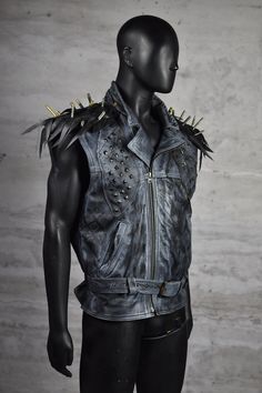 Step into the spotlight with our Rebel Edge Spiked Leather Vest, a statement piece designed for the bold and the brave. Crafted from hand-painted leather and adorned with hand-placed metal studs, this vest embodies the spirit of rebellion. The shoulder tassels, made from upcycled bicycle inner tubes and decorated with authentic bicycle valves, add an eco-friendly twist to your punk-rock look. Perfect for those who ride against the wind, this vest is your armor in the urban jungle. Strap on your Dystopian Costume, Shoulder Tassels, Heavy Metal Style, Post Apocalyptic Clothing, Apocalyptic Clothing, Heavy Metal Fashion, Stage Outfit, Hand Painted Leather, Mens Vests