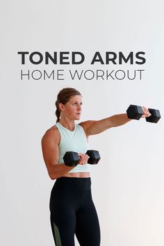 a woman holding two black dumbs while standing in front of a white wall with the words toned arms home workout