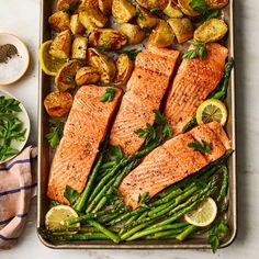 salmon, potatoes and asparagus on a baking sheet