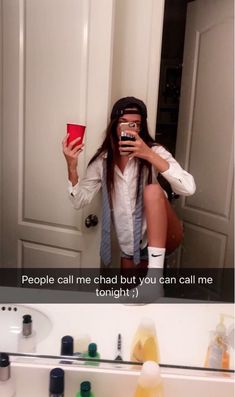 a woman taking a selfie in front of a bathroom mirror and holding a cup with the caption people call me chad but you can call me tonight