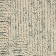 a close up view of the texture of a rug with blue and white stripes on it