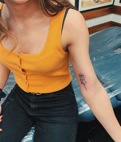 a woman with a small tattoo on her arm