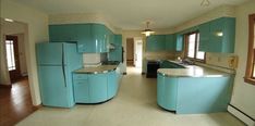 a kitchen with blue cabinets and counter tops in the middle of an open floor plan