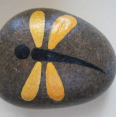 a rock with yellow and black designs on it