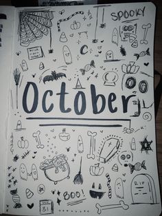 an open notebook with the word october written on it, surrounded by doodles and monsters