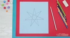 a paper with a star drawn on it next to colored pencils and crayons