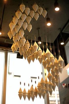 a bunch of paper lanterns hanging from the ceiling