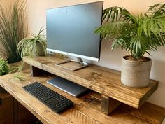 a computer monitor sitting on top of a wooden desk next to a keyboard and mouse