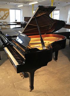 a black grand piano sitting in a living room