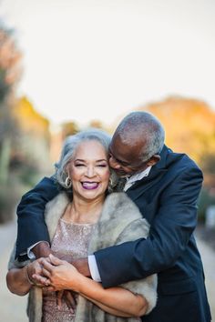 an older couple embracing each other on the street