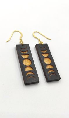 wooden earrings with sun and moon designs on them