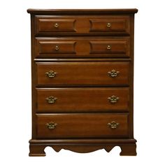 a wooden dresser sitting on top of a white wall