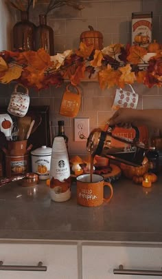 the kitchen counter is cluttered with dishes, cups and utensils on it