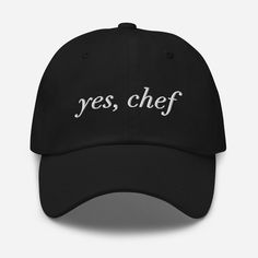 "YES CHEF EMBROIDERED BASEBALL CAP Low profile with an adjustable strap and curved visor. * 100% chino cotton twill * Unstructured, 6-panel, low-profile * 6 embroidered eyelets * 3 ⅛\" (7.6 cm) crown * Adjustable strap with antique buckle This product is made especially for you as soon as you place an order, which is why it takes us a bit longer to deliver it to you. Making products on demand instead of in bulk helps reduce overproduction, so thank you for making thoughtful purchasing decisions!" Yes Chef, Novelty Hats, Softball Bats, Best Caps, Men's Baseball Cap, Chef Hat, Hat Embroidery, Embroidered Baseball, Chefs Hat