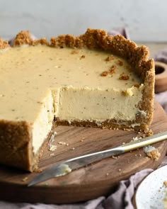 a piece of cheesecake on a wooden cutting board