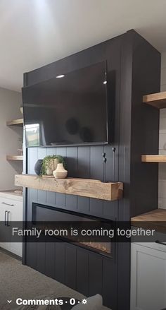 a flat screen tv mounted to the side of a wall in a living room with built - in shelving