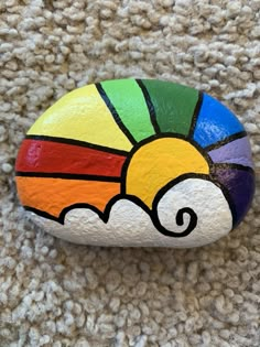 a painted rock sitting on top of a carpet