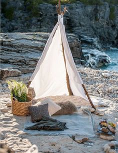 a teepee sitting on top of a sandy beach