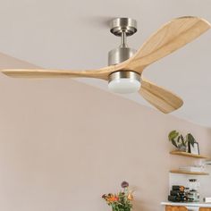 a ceiling fan with wooden blades in a living room