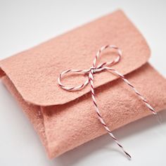 a pink envelope with a string tied to it