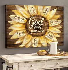 a sunflower with the words god says you are on it in front of a wooden table