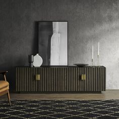 a black and gold sideboard with two candles on it next to a brown chair