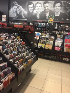 the inside of a record store with many records on display in front of large televisions