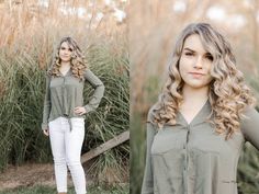 a beautiful young woman standing in front of some tall grass and looking at the camera