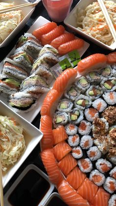 an assortment of sushi on plates with chopsticks