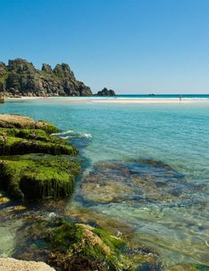 the water is crystal blue and clear with green algae growing on it's rocks