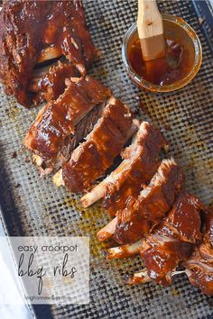 bbq ribs with barbecue sauce on the side and wooden skewers next to them