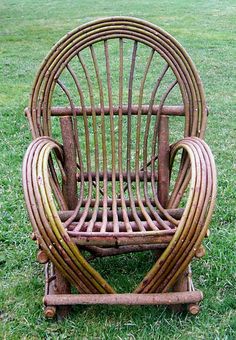 a wicker chair sitting on top of a lush green field