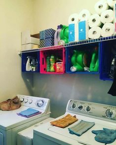 a washer and dryer sitting next to each other in front of a wall