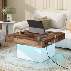 a laptop computer sitting on top of a wooden table in a living room next to a white couch