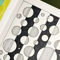 a close up of a piece of paper with circles and lines drawn on the side