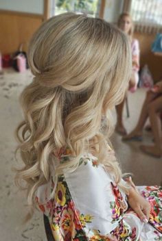 a woman with blonde hair is wearing a flowered dress